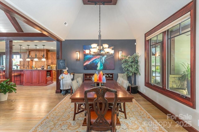 2461 Eagles Nest Rd, Waynesville, NC 28786 - dining space with light wood-style flooring, a chandelier, and high vaulted ceiling