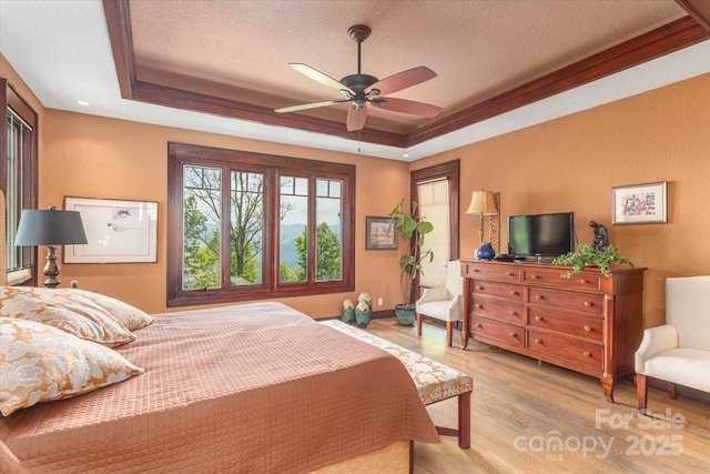 2461 Eagles Nest Rd, Waynesville, NC 28786 - bedroom with a tray ceiling, wood finished floors, a textured ceiling, and a ceiling fan