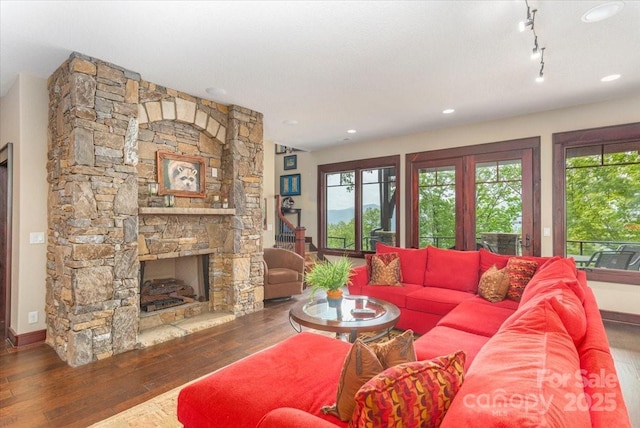 2461 Eagles Nest Rd, Waynesville, NC 28786 - living room featuring wood-type flooring, plenty of natural light, a stone fireplace, and baseboards