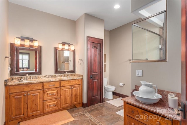 2461 Eagles Nest Rd, Waynesville, NC 28786 - full bathroom with double vanity, toilet, and baseboards