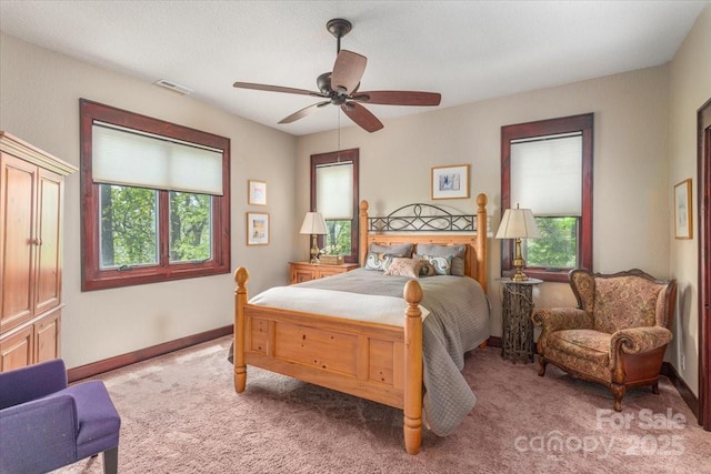 2461 Eagles Nest Rd, Waynesville, NC 28786 - carpeted bedroom with multiple windows, baseboards, and ceiling fan