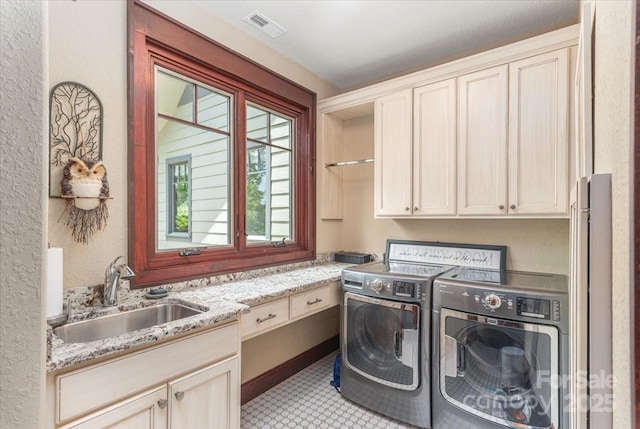2461 Eagles Nest Rd, Waynesville, NC 28786 - washroom featuring washer and clothes dryer, cabinet space, and a textured wall