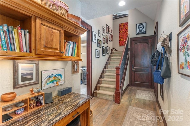 2461 Eagles Nest Rd, Waynesville, NC 28786 - foyer with light wood finished floors, stairs, and a textured wall