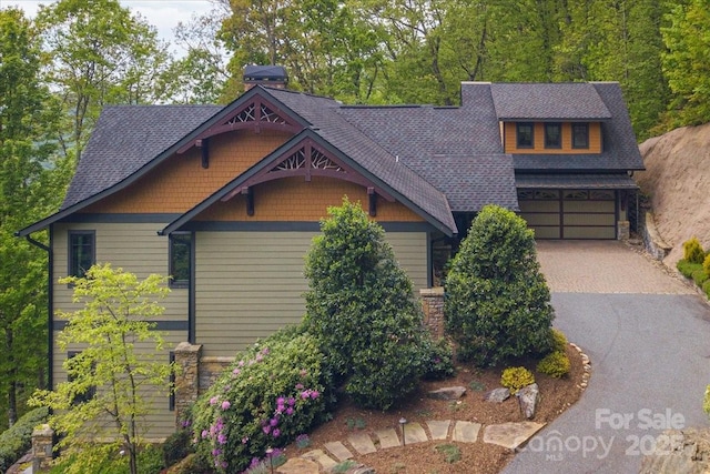 2461 Eagles Nest Rd, Waynesville, NC 28786 - craftsman house with asphalt driveway, a garage, stone siding, roof with shingles, and a chimney
