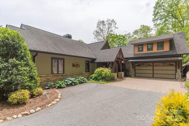 2461 Eagles Nest Rd, Waynesville, NC 28786 - view of front of property with stone siding, asphalt driveway, a shingled roof, and a chimney