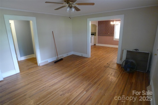 unfurnished room featuring a chandelier, wood finished floors, a ceiling fan, crown molding, and baseboards