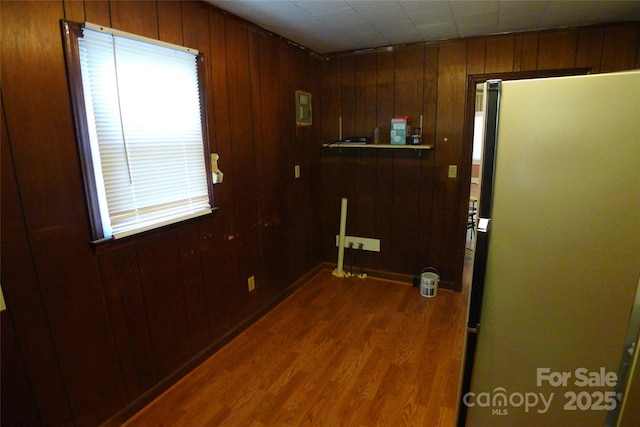 entryway with dark wood-style floors and wooden walls