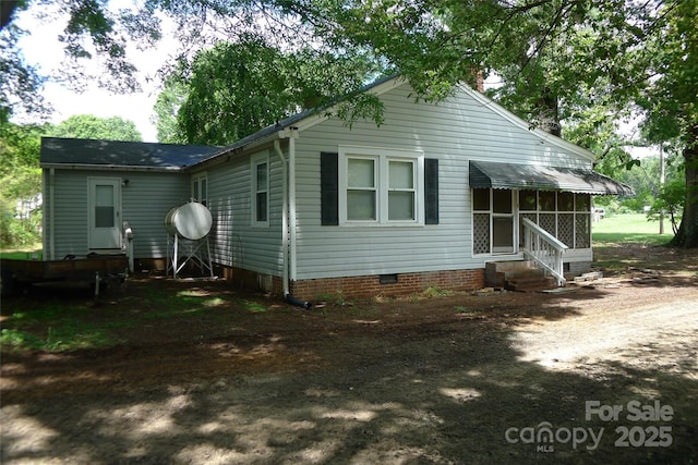 back of property with entry steps and crawl space