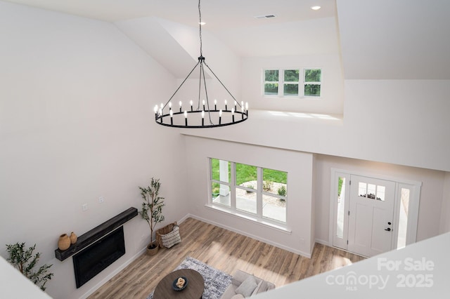 207 9th Ct NE, Conover, NC 28613 - entrance foyer with wood finished floors, healthy amount of natural light, high vaulted ceiling, a chandelier, and recessed lighting