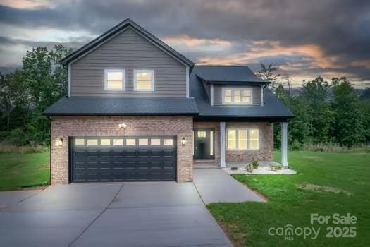 207 9th Ct NE, Conover, NC 28613 - view of front facade featuring a garage, concrete driveway, a front yard, and brick siding