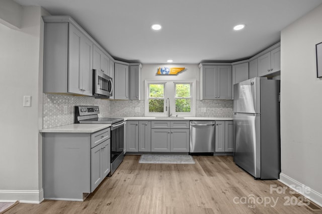 5371 Davidson Rd, Davidson, NC 28036 - kitchen with stainless steel appliances, gray cabinets, a sink, backsplash, and recessed lighting