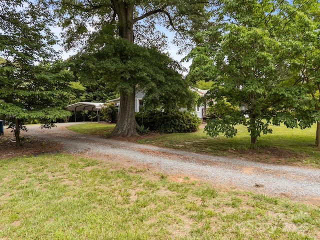 5371 Davidson Rd, Davidson, NC 28036 - view of green lawn featuring dirt driveway and a detached carport