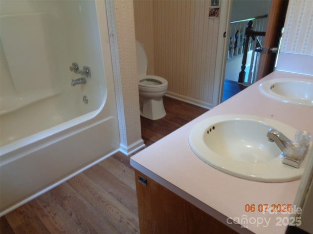 1203 Dudley Shoals Rd, Granite Falls, NC 28630 - full bathroom with wood finished floors, baseboards, double vanity, and toilet