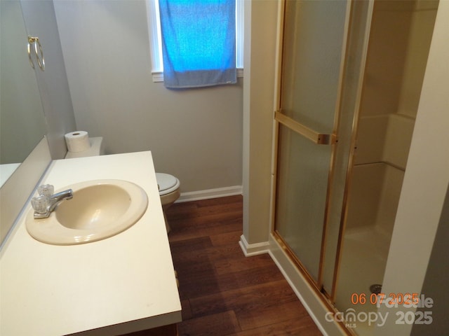 1203 Dudley Shoals Rd, Granite Falls, NC 28630 - bathroom featuring wood finished floors, a stall shower, toilet, vanity, and baseboards