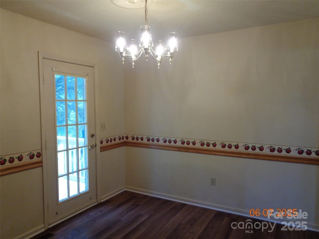 1203 Dudley Shoals Rd, Granite Falls, NC 28630 - spare room featuring a chandelier, dark wood-style floors, plenty of natural light, and baseboards