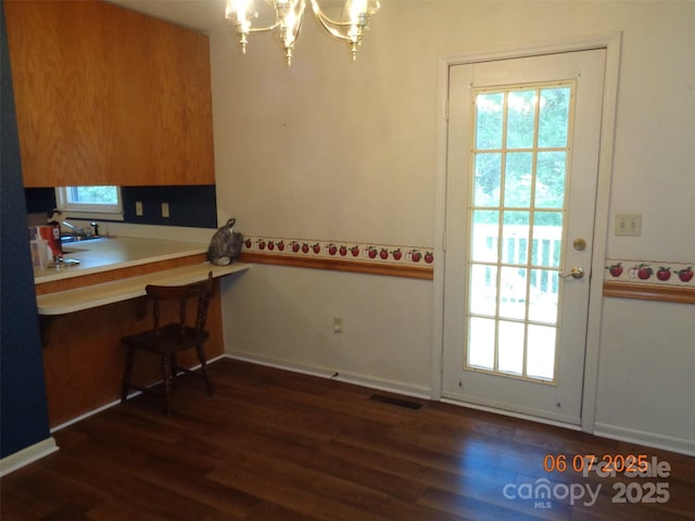 1203 Dudley Shoals Rd, Granite Falls, NC 28630 - unfurnished dining area featuring a chandelier, dark wood-type flooring, baseboards, and a sink