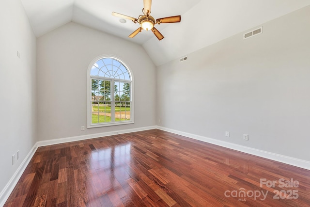 spare room with vaulted ceiling, a ceiling fan, wood finished floors, and baseboards