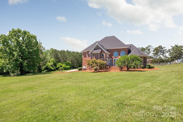 view of front of home with brick siding and a front lawn