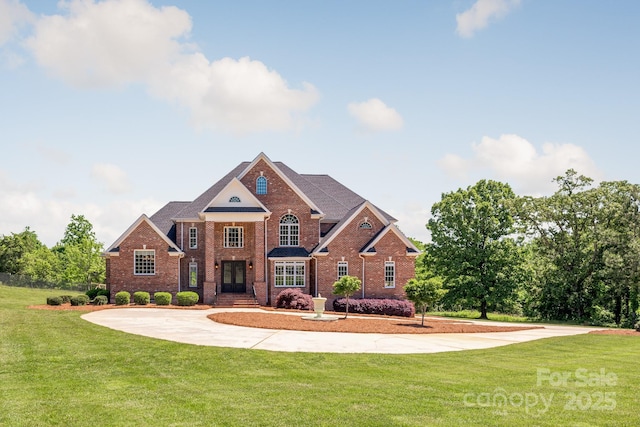 view of front of house with brick siding and a front yard