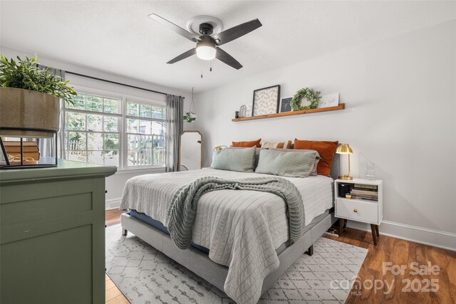 3900 Langley Rd, Charlotte, NC 28215 - bedroom featuring baseboards, light wood-type flooring, and ceiling fan