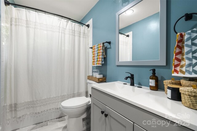 3900 Langley Rd, Charlotte, NC 28215 - full bathroom featuring vanity, toilet, marble finish flooring, and shower / tub combo