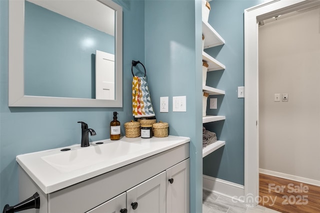 3900 Langley Rd, Charlotte, NC 28215 - bathroom with baseboards, vanity, and wood finished floors
