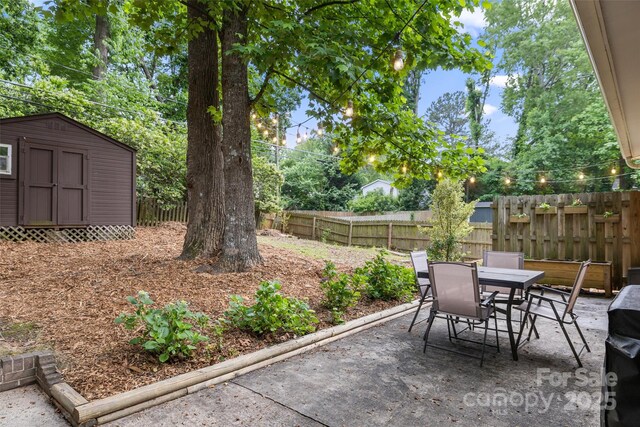 3900 Langley Rd, Charlotte, NC 28215 - view of patio / terrace featuring a storage shed, outdoor dining area, a fenced backyard, and an outdoor structure