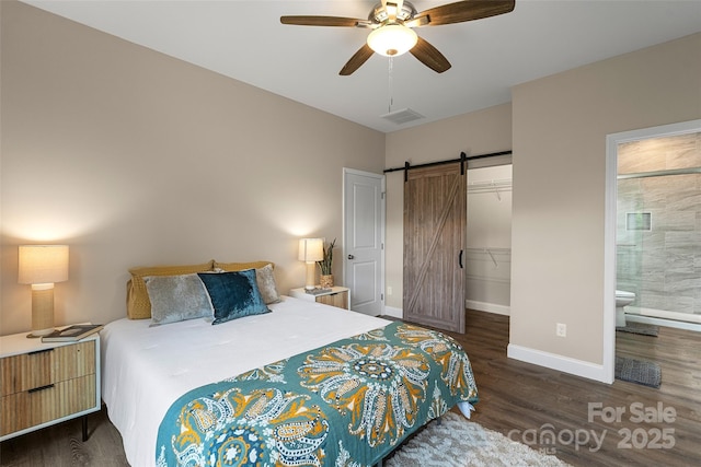 43 Clarks Chapel Ext, Weaverville, NC 28787 - bedroom with a barn door, wood finished floors, and baseboards