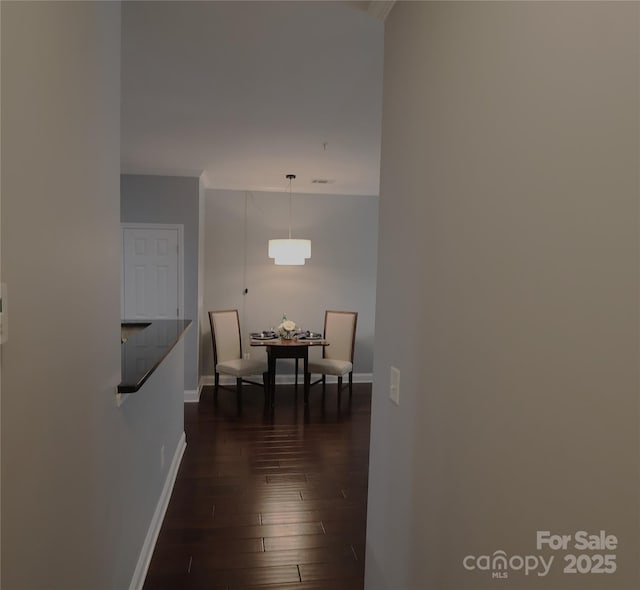 1000 E Woodlawn Rd Unit 107, Charlotte, NC 28209 - hall with dark wood-style flooring, baseboards, and ornamental molding