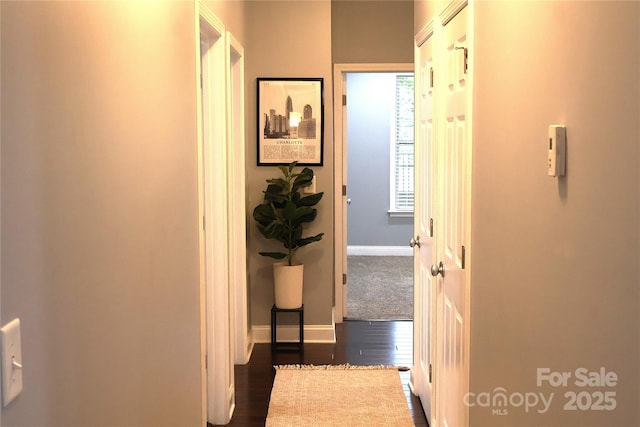1000 E Woodlawn Rd Unit 107, Charlotte, NC 28209 - corridor with baseboards and dark wood-type flooring