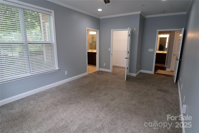 1000 E Woodlawn Rd Unit 107, Charlotte, NC 28209 - unfurnished bedroom featuring carpet flooring, baseboards, crown molding, connected bathroom, and recessed lighting