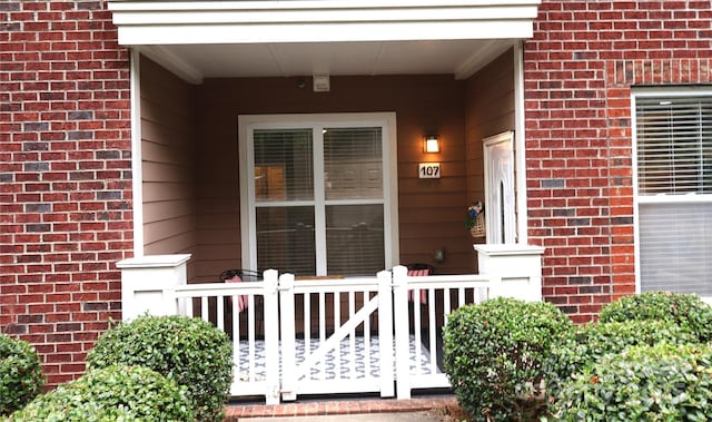 1000 E Woodlawn Rd Unit 107, Charlotte, NC 28209 - view of exterior entry featuring brick siding