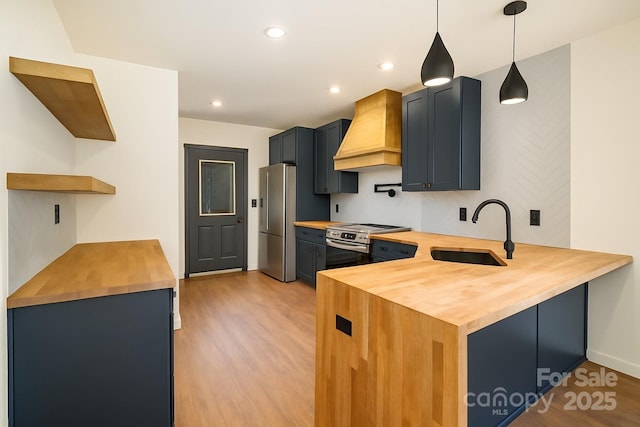415 S Boyd St, Gastonia, NC 28052 - kitchen featuring wood counters, custom range hood, a sink, light wood-style flooring, and recessed lighting