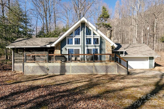 491 Mckenzie Way S, Old Fort, NC 28762 - back of house with a chimney, stone siding, a deck, and roof with shingles