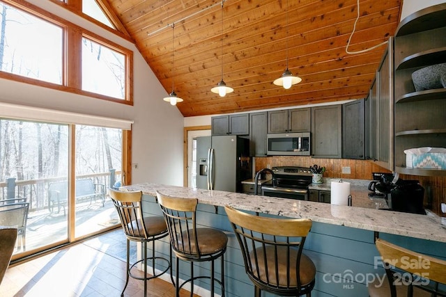 491 Mckenzie Way S, Old Fort, NC 28762 - kitchen with appliances with stainless steel finishes, open shelves, a peninsula, wood ceiling, and light stone counters