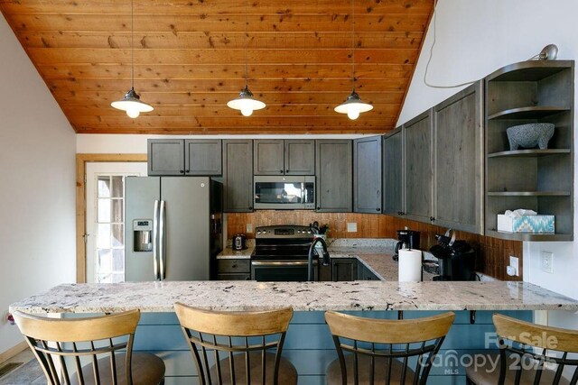 491 Mckenzie Way S, Old Fort, NC 28762 - kitchen featuring appliances with stainless steel finishes, lofted ceiling, wooden ceiling, a peninsula, and light stone counters