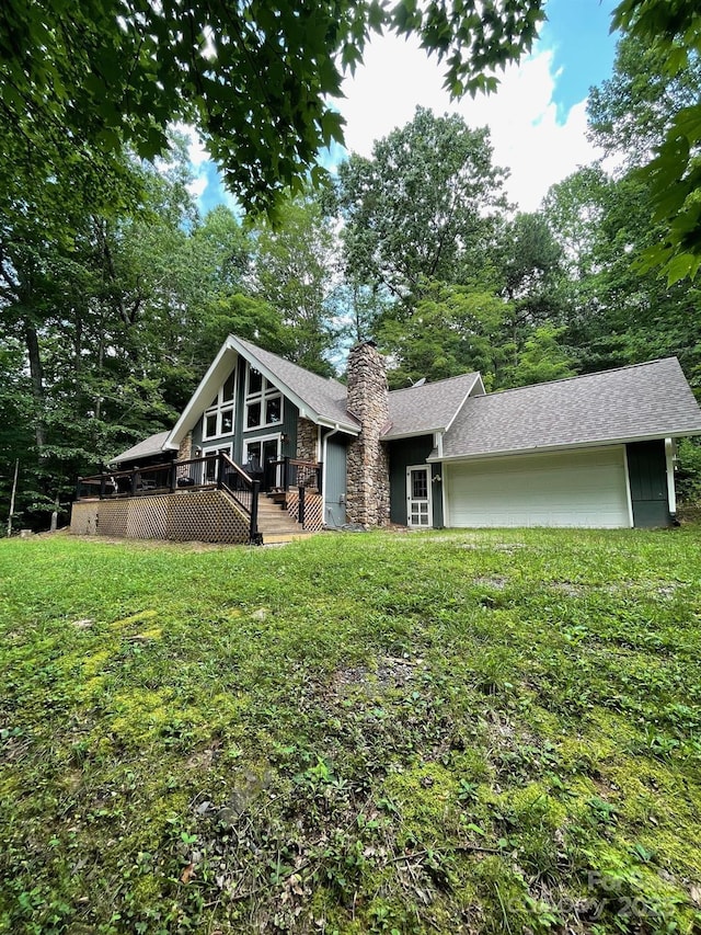 491 Mckenzie Way S, Old Fort, NC 28762 - back of property featuring a chimney, a lawn, a deck, an attached garage, and roof with shingles