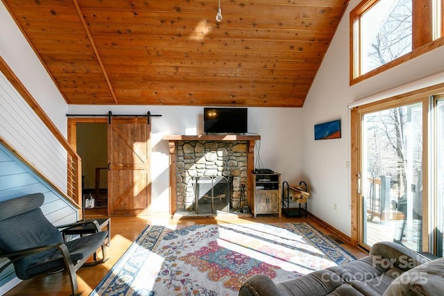 491 Mckenzie Way S, Old Fort, NC 28762 - living area featuring wooden ceiling, wood finished floors, a barn door, high vaulted ceiling, and a stone fireplace