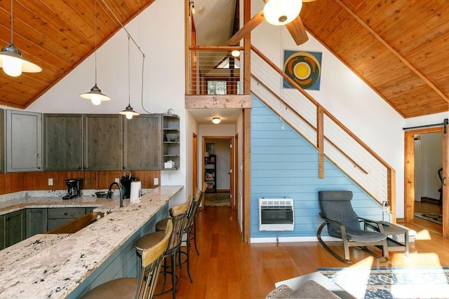 491 Mckenzie Way S, Old Fort, NC 28762 - kitchen featuring heating unit, a wooden ceiling with exposed beams, high vaulted ceiling, light stone countertops, and wood finished floors