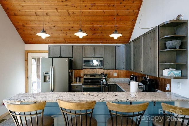 491 Mckenzie Way S, Old Fort, NC 28762 - kitchen with stainless steel appliances, vaulted ceiling, wooden ceiling, a peninsula, and light stone countertops