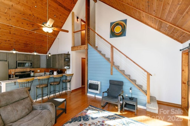 491 Mckenzie Way S, Old Fort, NC 28762 - living area featuring high vaulted ceiling, wood ceiling, wood finished floors, heating unit, and stairs