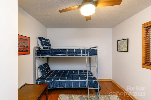 491 Mckenzie Way S, Old Fort, NC 28762 - bedroom with wood finished floors, a textured ceiling, and a ceiling fan