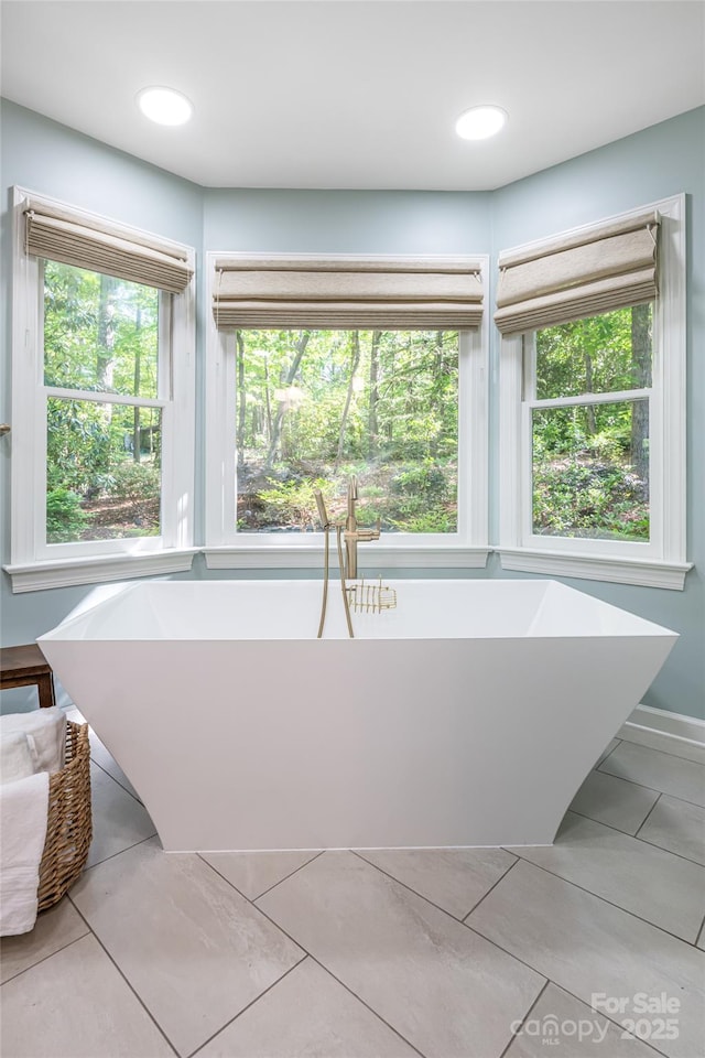 287 Anne St, Rutherfordton, NC 28139 - full bath featuring plenty of natural light, a freestanding bath, and tile patterned floors