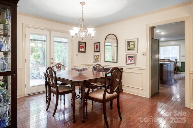 287 Anne St, Rutherfordton, NC 28139 - dining room featuring dark wood-type flooring, ornamental molding, healthy amount of natural light, a chandelier, and wainscoting