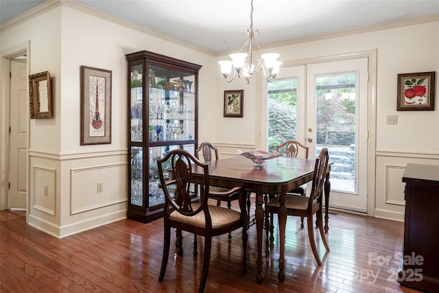 287 Anne St, Rutherfordton, NC 28139 - dining area featuring a decorative wall, crown molding, dark wood-style floors, a chandelier, and a wainscoted wall