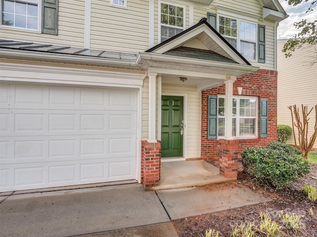 4208 Everest Dr, Gastonia, NC 28054 - view of exterior entry featuring brick siding, driveway, and an attached garage