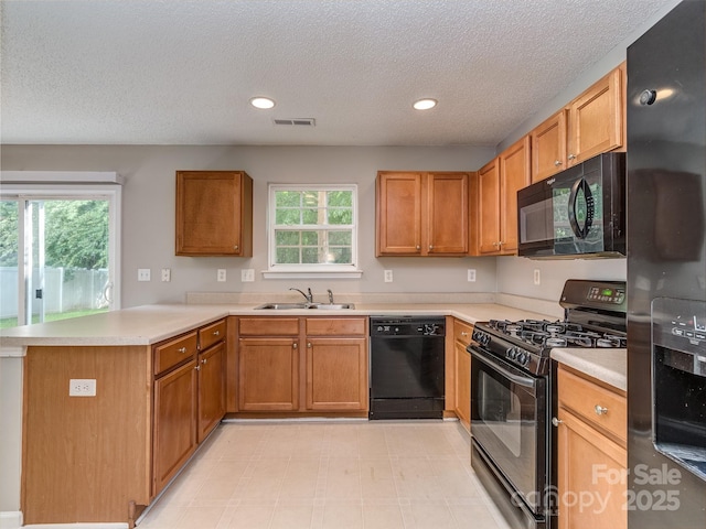 4208 Everest Dr, Gastonia, NC 28054 - kitchen featuring black appliances, a sink, a peninsula, light countertops, and a textured ceiling