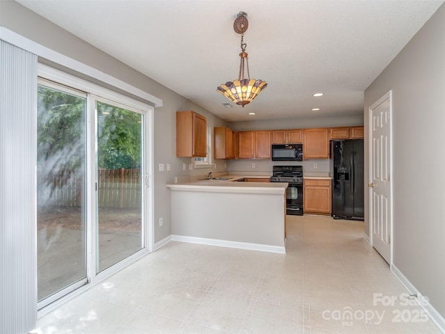 4208 Everest Dr, Gastonia, NC 28054 - kitchen with black appliances, light countertops, pendant lighting, a peninsula, and recessed lighting
