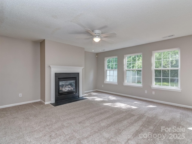 4208 Everest Dr, Gastonia, NC 28054 - unfurnished living room with carpet floors, ceiling fan, a textured ceiling, a fireplace with flush hearth, and baseboards