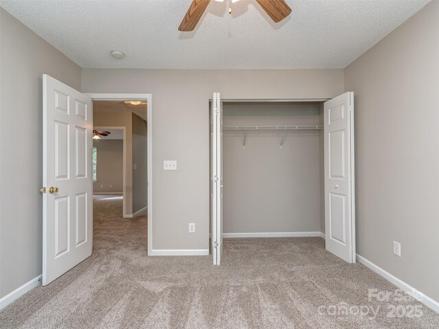 4208 Everest Dr, Gastonia, NC 28054 - unfurnished bedroom featuring carpet flooring, a closet, a textured ceiling, ceiling fan, and baseboards